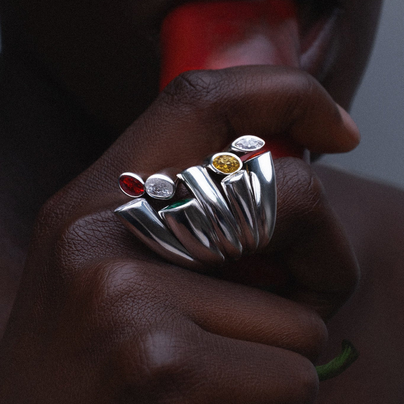 Model wearing Cocoerow Bella Ring in sterling silver with diamonds, emerald, amethyst, and sapphires